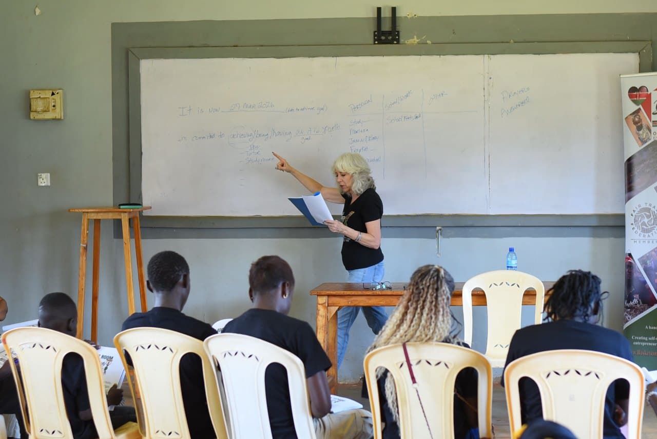 Eldonna teaching a seated class at a whiteboard